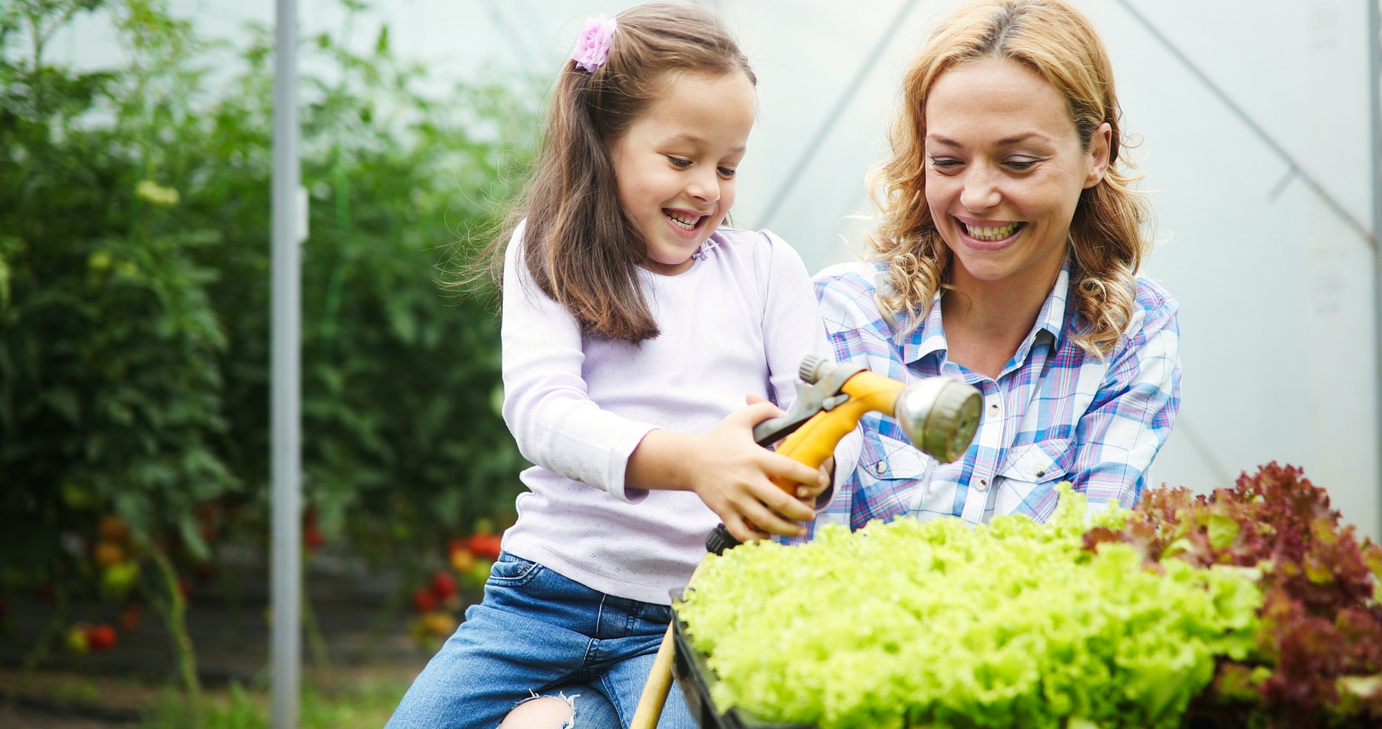 Little girl having fun in the garden, planting, gardening, helping her mother